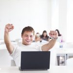 istock Portrait of a very happy young, male college student working on