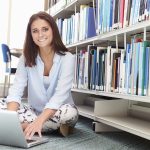 istock Female College Student Studying In Library With Laptop